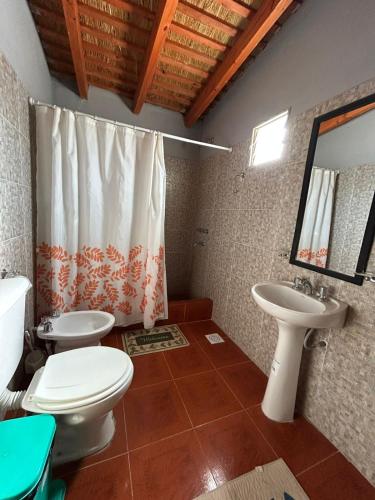 a bathroom with a toilet and a sink at Hospedaje Don Carmelo in El Peñón