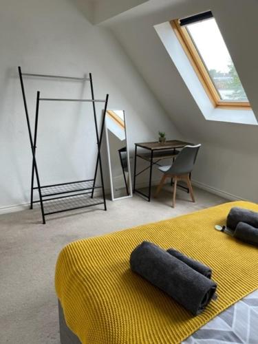a room with a bed and a table and a window at Spring House - Staycation - Perfect for Contractors & Families - 2 Parking Spaces in Dudley