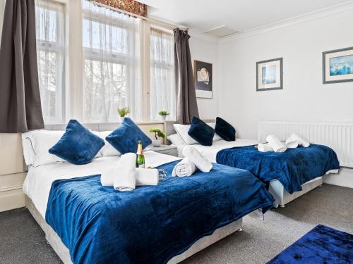 two beds in a room with blue and white at Rising Sun in Rogerstone