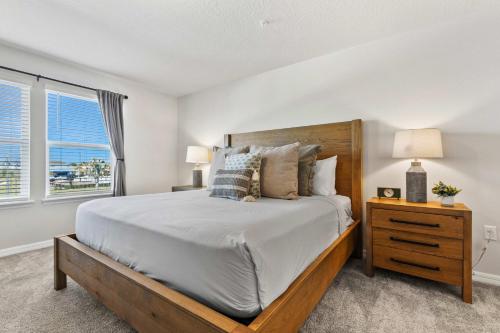 a bedroom with a large bed and a window at 16148 Palm Frond Ave in Orlando