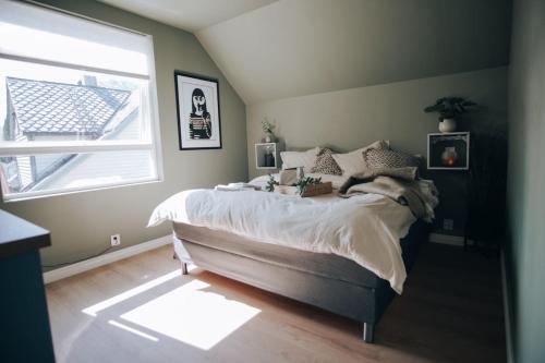 a bedroom with a large bed and a window at Odda Apartments - 2BR & 3BR - Parking - T32 in Odda