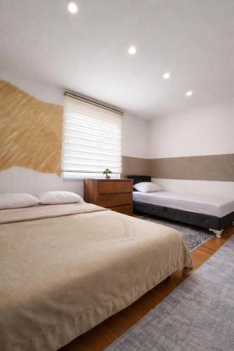 a bedroom with two beds and a window at Sarajevo Old Town 1 Free Parking & RoofTop View in Sarajevo
