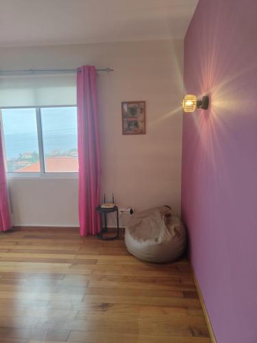 a room with a bed in the corner of a room at Alcantara Bell in Feiteiras