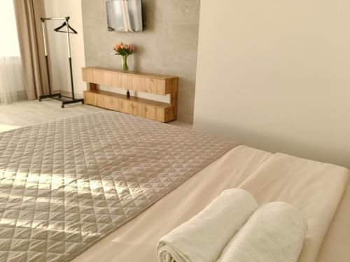 a bedroom with a bed with two towels on it at Comfort House Партизанська 25 in Bila Tserkva