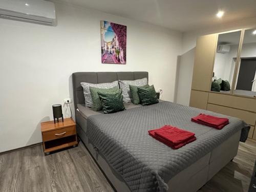 a bedroom with a bed with two red towels on it at Villa Erwin with heated pool in Imotski