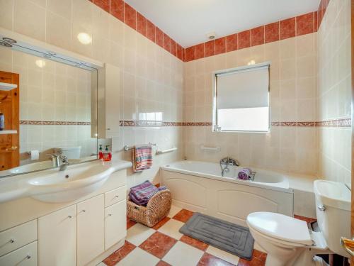 a bathroom with a tub and a sink and a toilet at 3 Bed in Renvyle oc-i254 in Cashleen