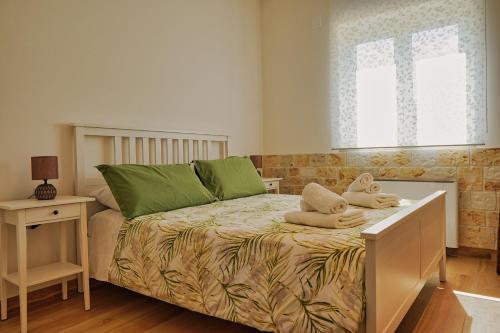a bedroom with a bed with towels on it at Malia Holiday Villa in Conversano