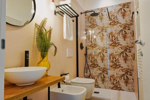 a bathroom with a sink and a toilet and a shower at Malia Holiday Villa in Conversano