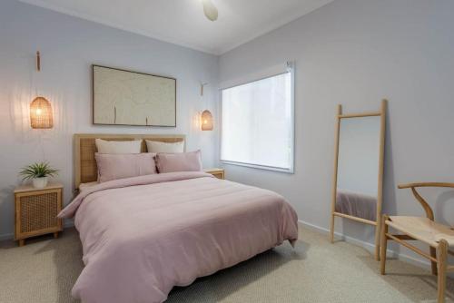a bedroom with a large bed and a window at Allawah in Encounter Bay