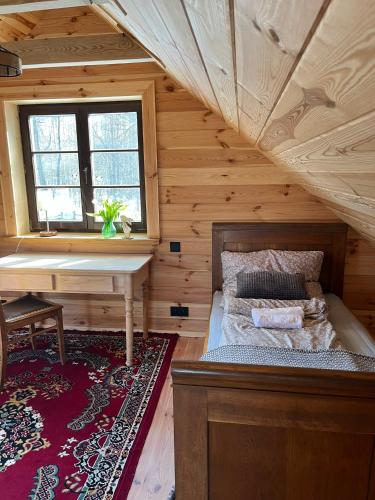 a bedroom with a bed and a piano in a room at Wiluki Nasz Dom in Wiluki