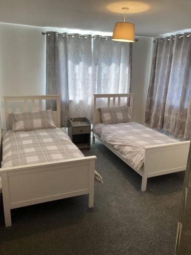 two beds sitting next to each other in a room at Gorgeous Marina 2 Bed Apartment in Portishead