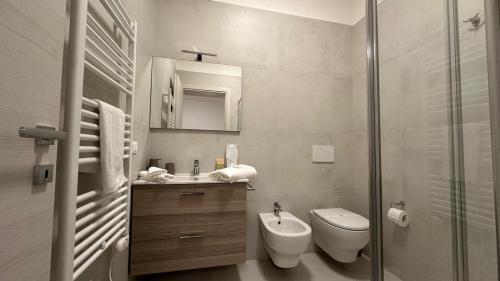 a bathroom with a toilet and a sink and a shower at Borgo San Michele Bed & Breakfast in Calvisano