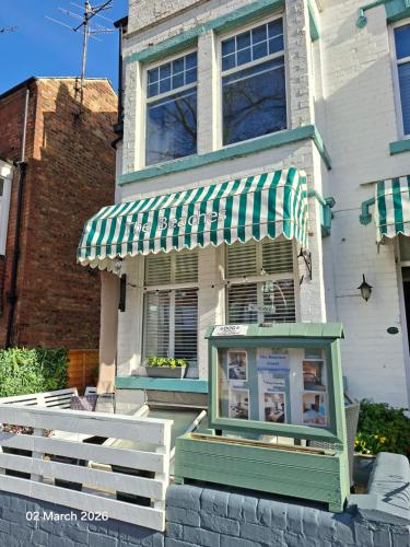 a house with a green and white awning at The Beaches in Scarborough