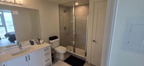 a bathroom with a shower and a toilet and a sink at Corner unit 3 bath and 2 bed in Vaughan