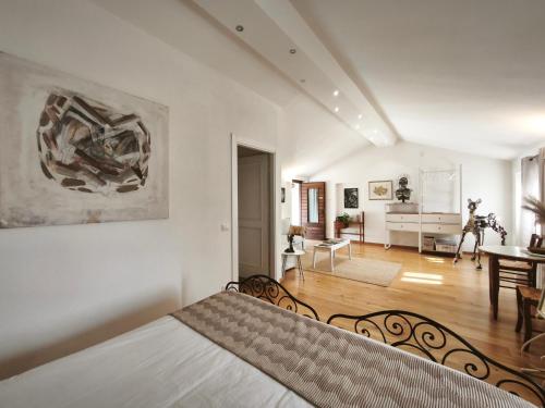 a bedroom with a bed and a living room at Cascina Borgofrancone in Gera Lario