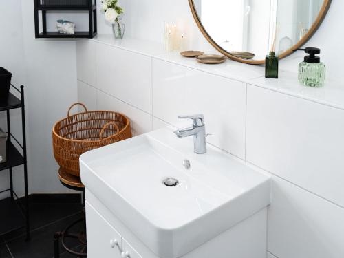 a bathroom with a white sink and a mirror at Altstadt Geverdes 1 in Lübeck