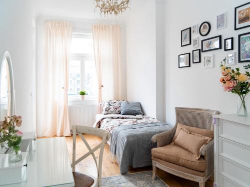 a bedroom with a bed and a chair and a window at Altstadt Geverdes 1 in Lübeck