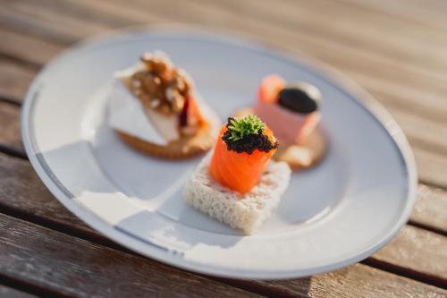 a plate of food on a wooden table at Nomad Greenland Camp Saqqaq in Saqqaq