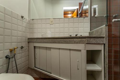 a bathroom with a sink and a mirror and a toilet at Rio´s Mansion: Sugar Loaf, The Redeemer and Pool in Rio de Janeiro