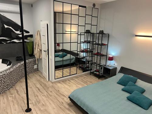 a bedroom with a bed and a large mirror at Romantic Room Šiauliai in Šiauliai