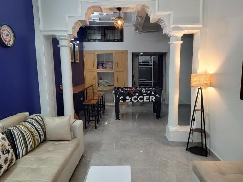 a living room with a couch and a table in it at Bed N Banter - Lucknow in Lucknow