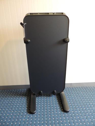 a black toilet in a room with a blue floor at Hotel Grand Terrace Sendai Kokubun-cho in Sendai