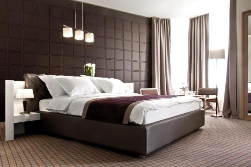 a bedroom with a large bed with white pillows at Jump INN Hotel Belgrade in Belgrade