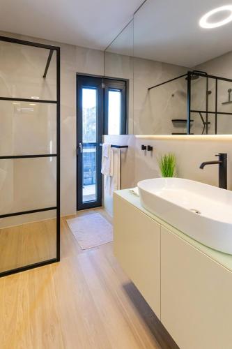 a bathroom with a large white sink and a shower at Luxury Villa Palermo in Vir
