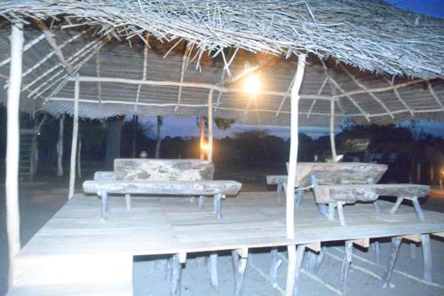 a pavilion with two couches and a table and benches at Yala Dream Park in Yala