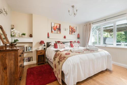 a bedroom with a large bed and a window at The Estate in Saltash