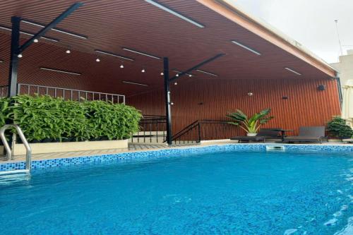 a large swimming pool in front of a building at San Hotel & Pool in Hanoi
