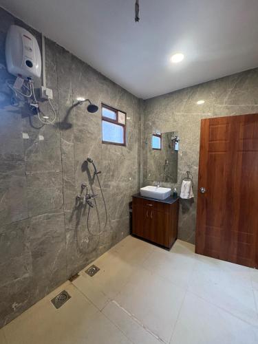 a bathroom with a shower and a sink at Half Orange in Vagator
