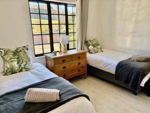 a bedroom with two beds and a window at 4 Laddswood Lodge in Hilton
