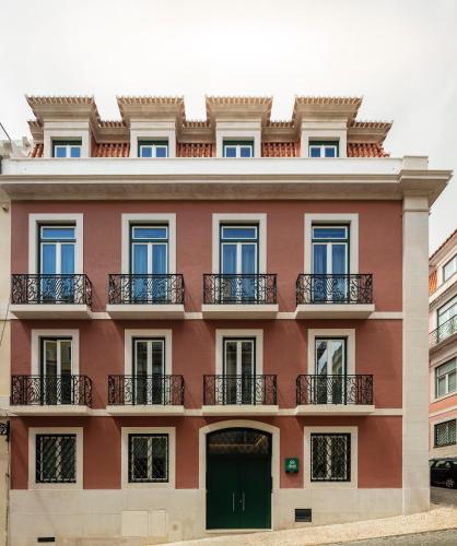 an apartment building with a green door and balcony at LSA Chiado Emenda by Numa in Lisbon