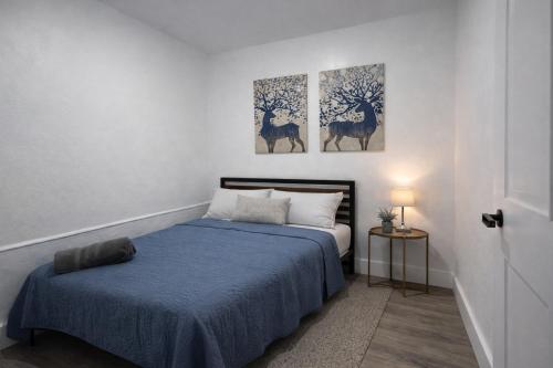 a bedroom with a bed and two paintings on the wall at Fort Lauderdale Airport Bleu Lagunna in Hollywood