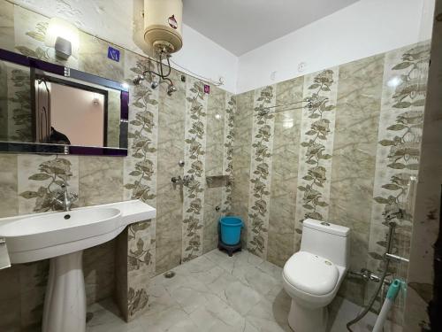 a bathroom with a sink and a toilet at Valley View in Dhanaulti
