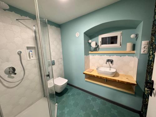 a bathroom with a sink and a toilet and a shower at Tessa Central House in Kőszeg