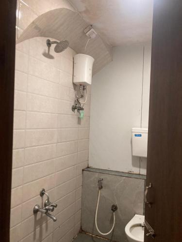 a bathroom with a toilet and a sink at Hotel Grants Residency Colaba in Mumbai