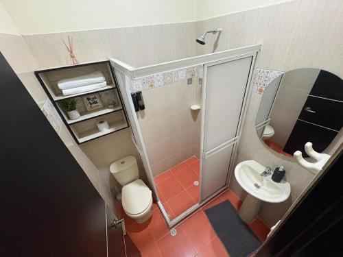 a small bathroom with a shower and a sink at Espacio Ideal 101 in Yopal