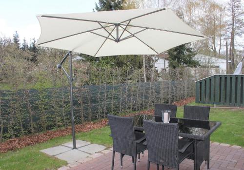 a table and chairs under an umbrella on a patio at Quartier Spreestraße - App 3 in Burg