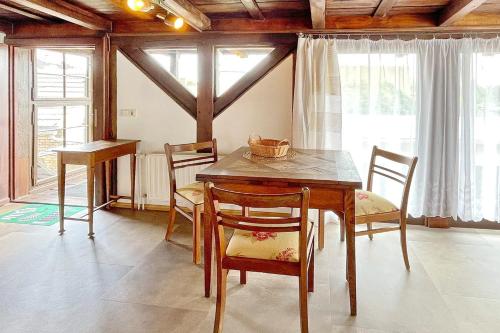 a dining room with a wooden table and chairs at Altstadtflair - Rüster in Lübbenau