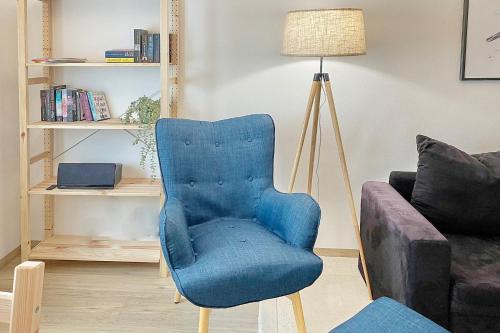 a blue chair in a living room next to a couch at Libelle in Lübben