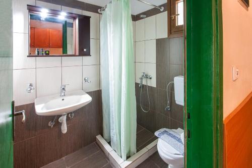 a bathroom with a sink and a toilet at Dream House in Agia Paraskevi