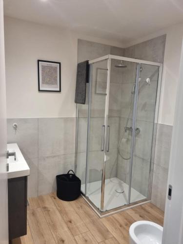a bathroom with a shower with a glass shower stall at L'Oasi Amena - Loft in Ameno
