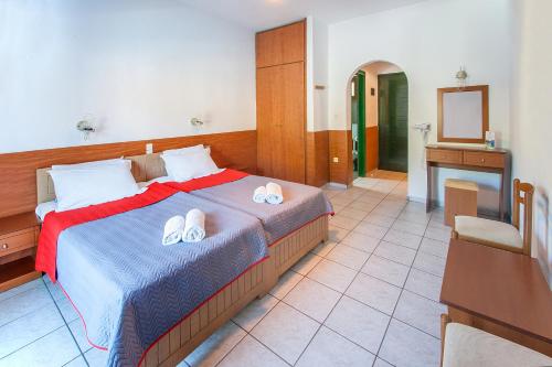 a bedroom with a bed with two slippers on it at Dream House in Agia Paraskevi