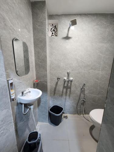 a bathroom with a sink and a toilet at The Trishul Stay in Varanasi