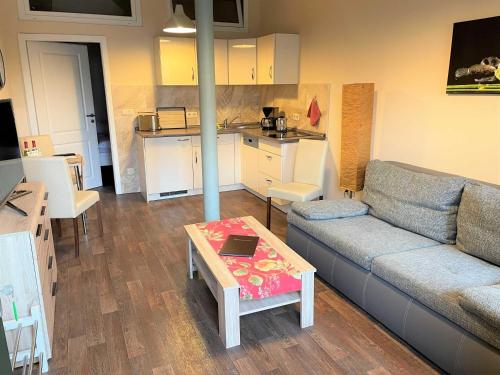 a living room with a couch and a table at Malz in Lübbenau