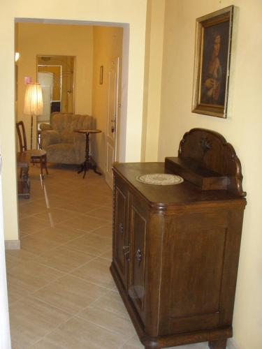 a living room with a wooden cabinet in a room at SHotels przy Restauracji Stodoła in Bartoszyce