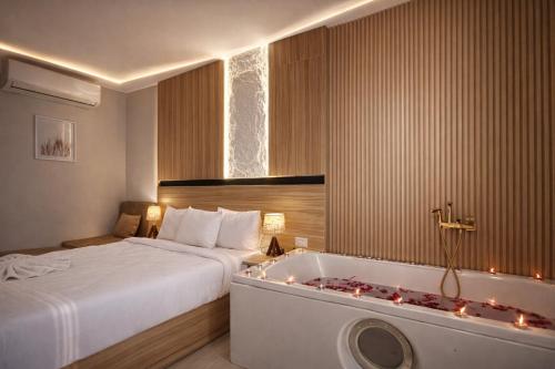 a hotel room with a bed and a bath tub at TAJ Suites Pyramids View Hotel in Cairo