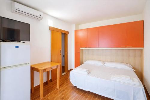 a small bedroom with a bed and a refrigerator at Terrazza sul Mare Case Vacanze in Capo Rizzuto